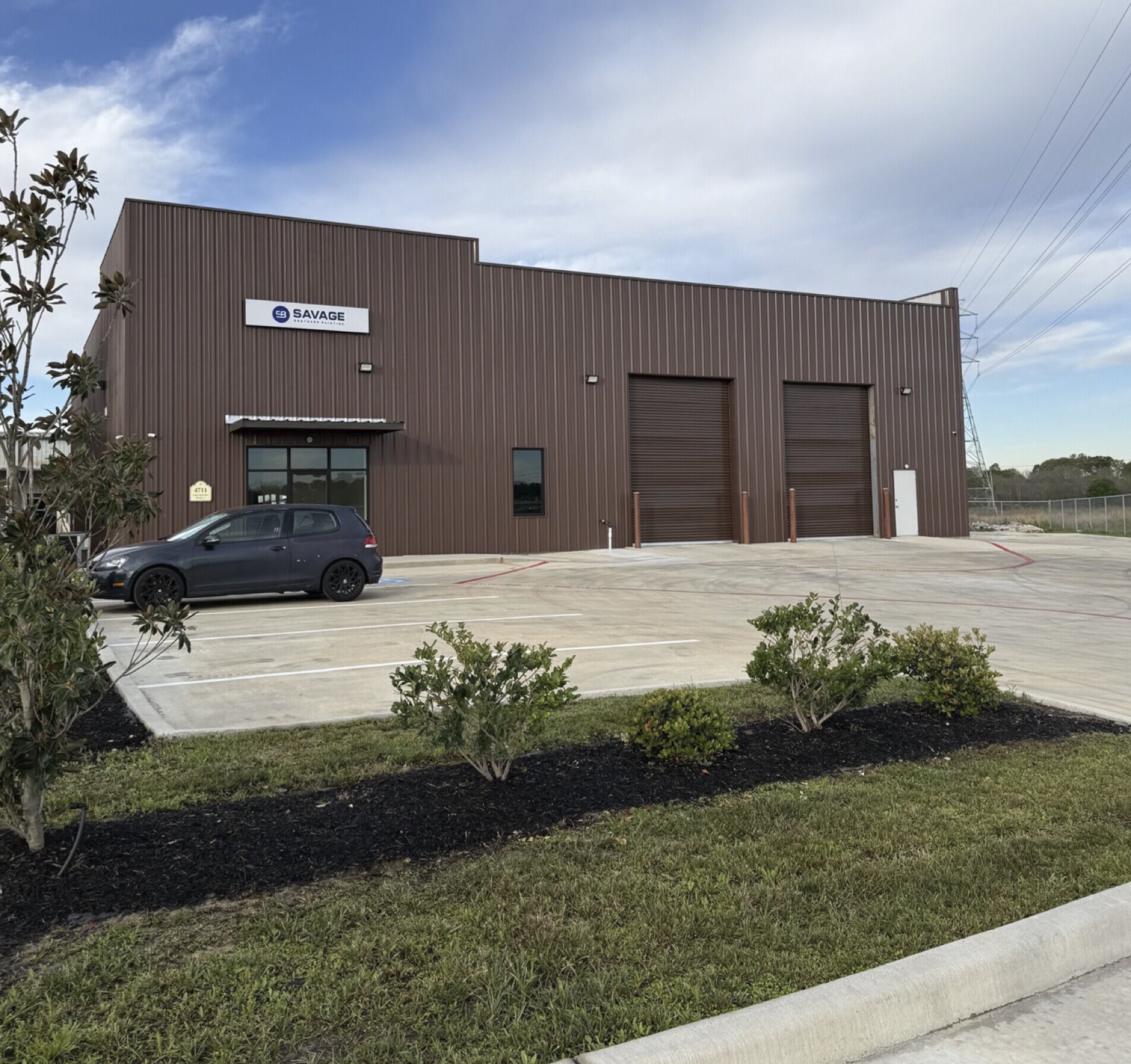 Finished brown industrial flex building with parking and landscaping